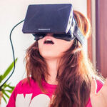 A woman wears the virtual reality headset Oculus Rift.