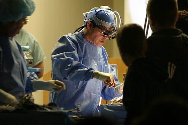 A doctor performs surgery.