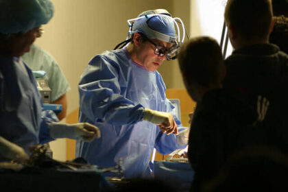 A doctor performs surgery