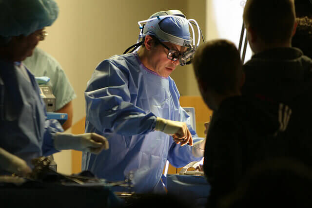 A doctor performs surgery