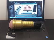Vstroker and Fleshlight resting on laptop keyboard