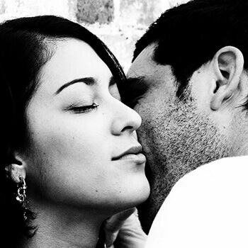 A couple hold each other close.