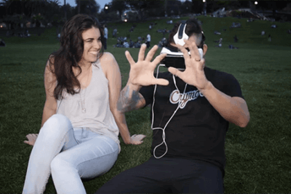 A man watches VR porn next to a woman.