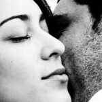 A couple hold each other close.