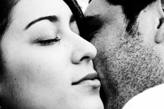 A couple hold each other close.