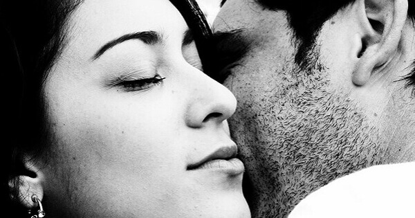 A couple hold each other close.
