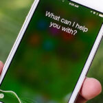 Voice assistant Siri asks if she can help.