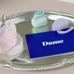 Eva and Fin, sex toys from Dame Products, on a platter.