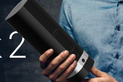 A man holds up the Kiiroo Onyx2 male sex sleeve.