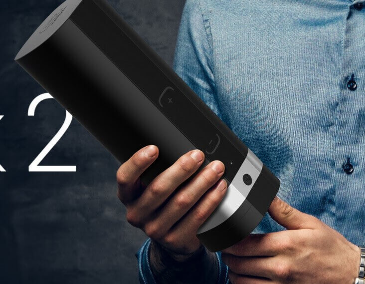 A man holds up the Kiiroo Onyx2 male sex sleeve.