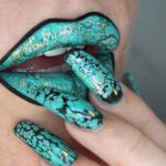 A woman with green-painted lips and nails.