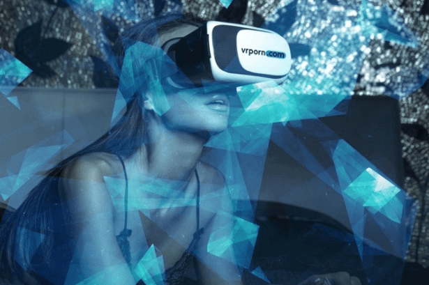 A barely clothed woman wears a head-mounted display VR headset.