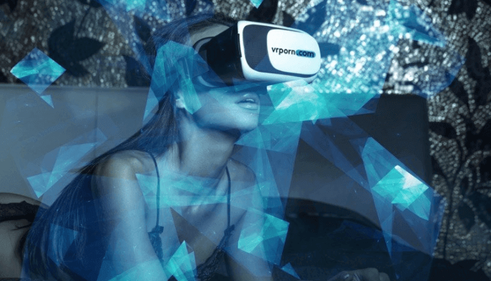 A barely clothed woman wears a head-mounted display VR headset.