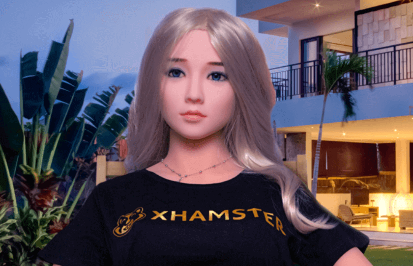 Sex doll xHamsterina appears with blonde hair, Asian features, and a black T-shirt.