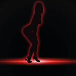 The silhouette of a woman, outlined in red, appears on a black background. The women is posed in a sexy stance, slightly bent and revealing she is wearing heels.