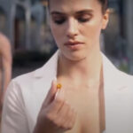 Woman looking at pill in Brave New World TV Show.