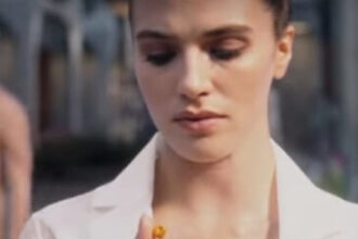 Woman looking at pill in Brave New World TV Show.