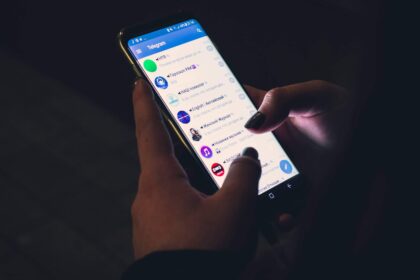 Closeup of a Telegram user scrolling the app on a smartphone.