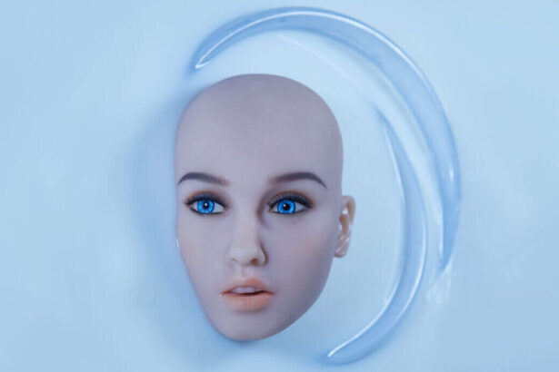 Kokeshis face and head, without hair, appears in a bath of white fluid.