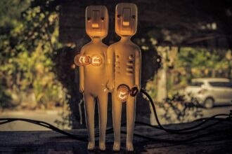 Two humanoid-looking lamps show light bulbs to represent breasts and the genital area.
