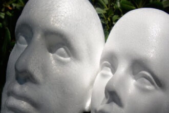 Screenshot of Styrofoam Faces of Male and Female In the Garden