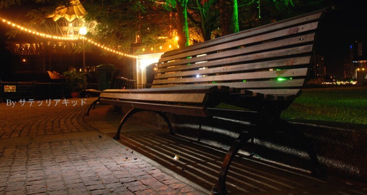 Image of Empty Bench in a Park with Beautiful Outdoor lights Display in Background