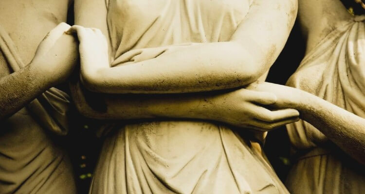 Image of Three Statues Holding their Hands
