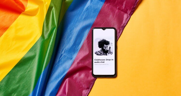 Clubhouse Invite-only Chat App Open in Mobile Phone with a Colorful Background