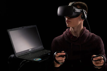 Image of a man using virtual reality devices and laptop
