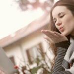 Screenshot of a girl sending flying kiss on a video call