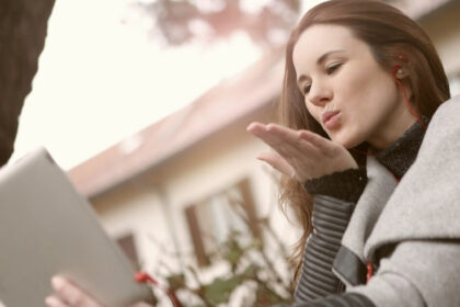 Screenshot of a girl sending flying kiss on a video call