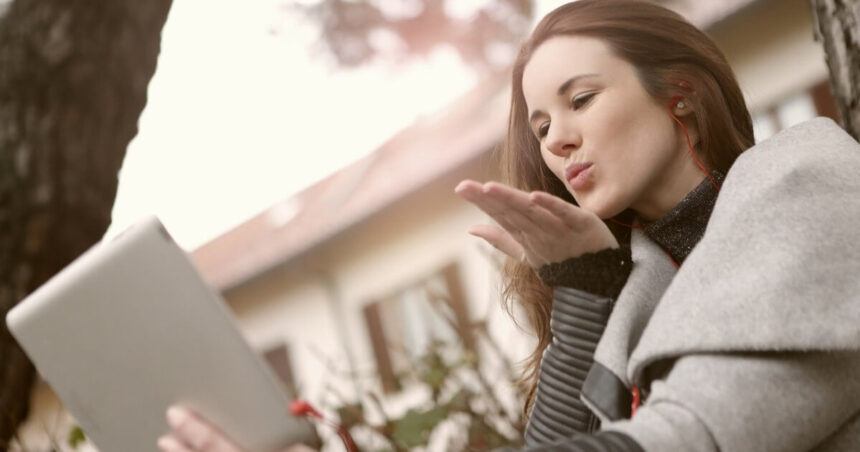 Screenshot of a girl sending flying kiss on a video call