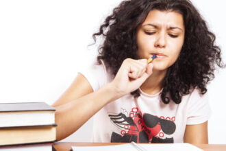 Woman studies with textbooks and notebook