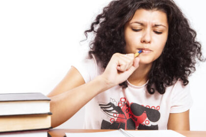 Woman studies with textbooks and notebook