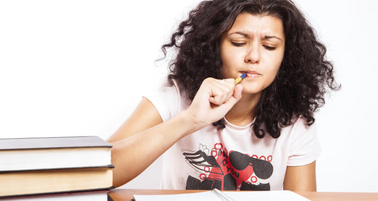 Woman studies with textbooks and notebook