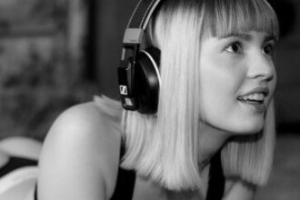 Black and white image of a young girl listening to music