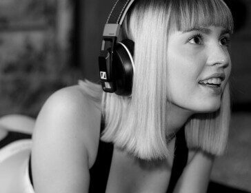 Black and white image of a young girl listening to music