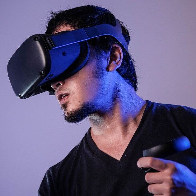Man wearing vr head gear and haptic controllers.