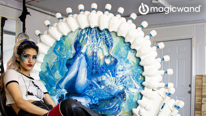 Dafne Blade sits next to her Pleasure as Art sculpture made of 100 Magic Wand vibrators. Credit: Vibratex