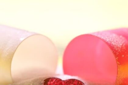 A heart gem comes out of an opened pill casing.