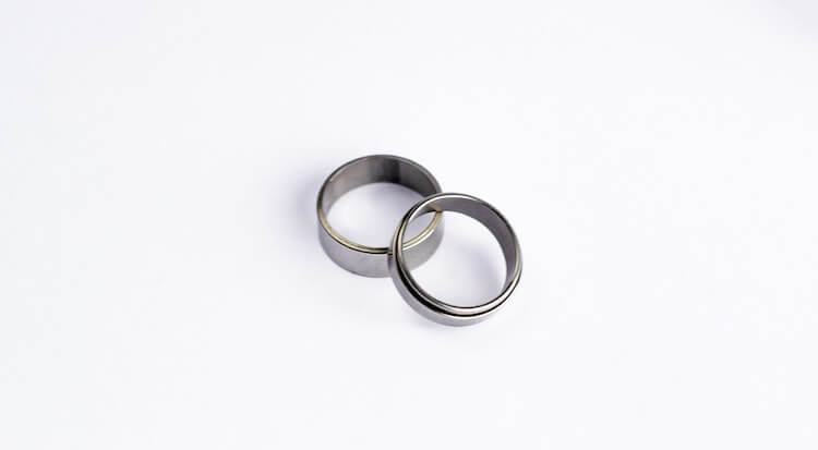 Two plain silver wedding bans sitting against a white background.