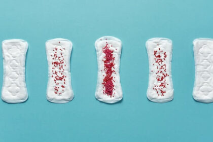 Five menstrual pads with varying degrees of red sprinkles on top to represent the various stages of periods.