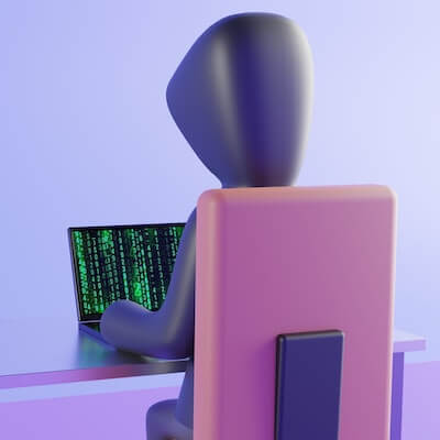 Clay-type model of a hacker in a hoodie at a desk. On the screen you see the stereotypical green code.