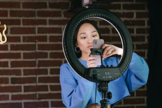 An influencer setting up her phone and ring light.