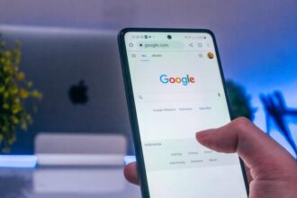 A phone lit up against a dark background, showing the Google search console.