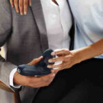 A couple with a woman sitting on a man's lap. They each are holding the Tenuto 2 with one hand.